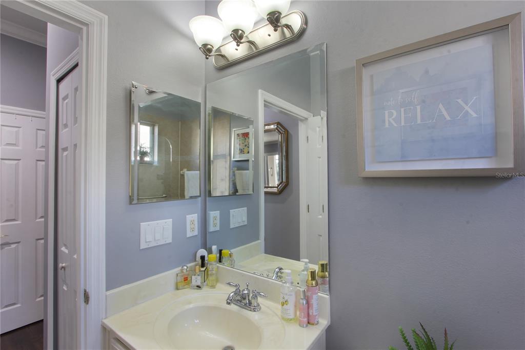 5536 Ansley Way Mount Dora, FL 32757 - Photo 29 of 49 a bathroom with a sink mirror and vanity
