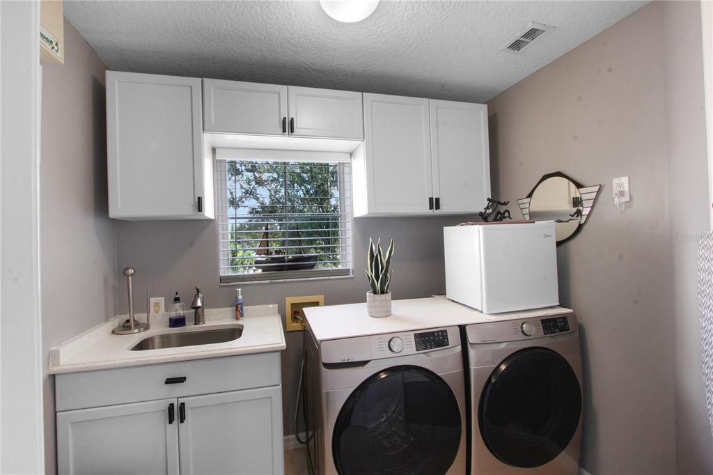 5536 Ansley Way Mount Dora, FL 32757 - Photo 30 of 49 a utility room with sink dryer and washer