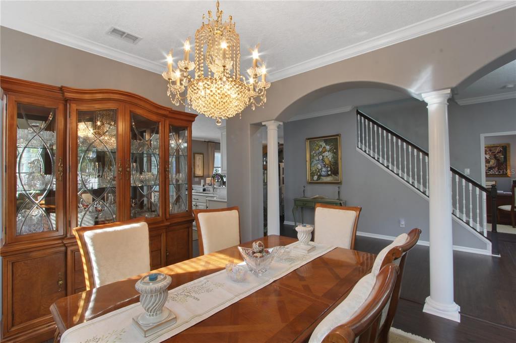 5536 Ansley Way Mount Dora, FL 32757 - Photo 31 of 49 a view of a dining room with furniture a chandelier and large windows