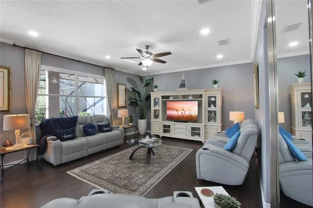 a living room with furniture and a view of kitchen