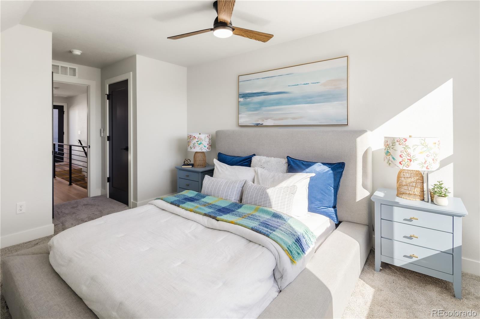 1343 Perry Street Denver, CO 80204 - Photo 26 of 37 a bedroom with a large bed and a chandelier