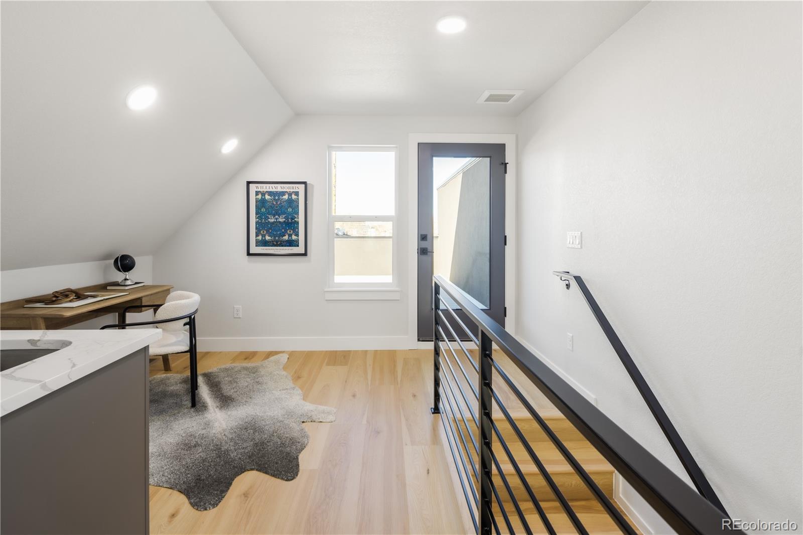 1343 Perry Street Denver, CO 80204 - Photo 27 of 37 a view of a livingroom with wooden floor and stairs