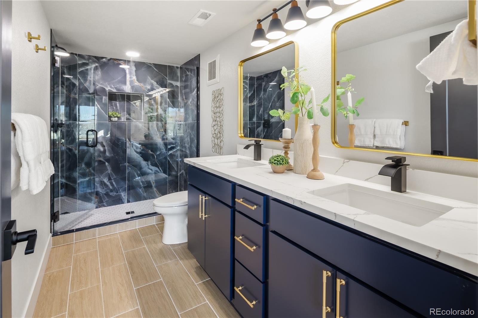 1343 Perry Street Denver, CO 80204 - Photo 3 of 37 a bathroom with a sink a double vanity and shower