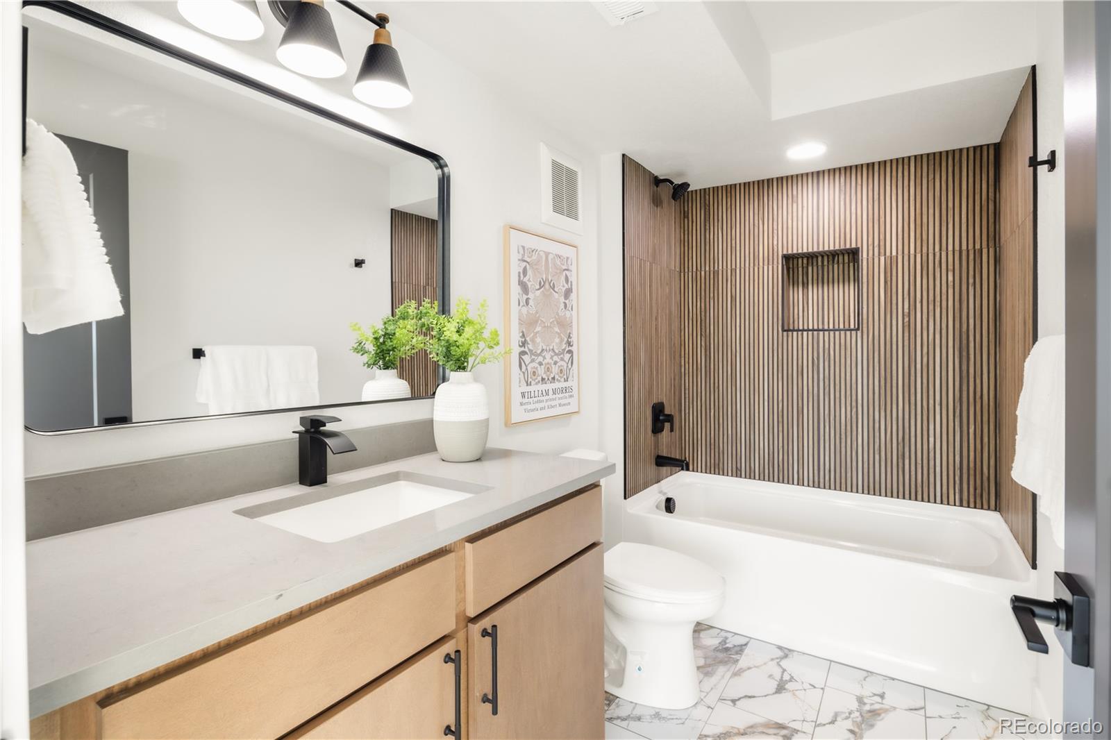 1343 Perry Street Denver, CO 80204 - Photo 5 of 37 a bathroom with a granite countertop tub sink and mirror