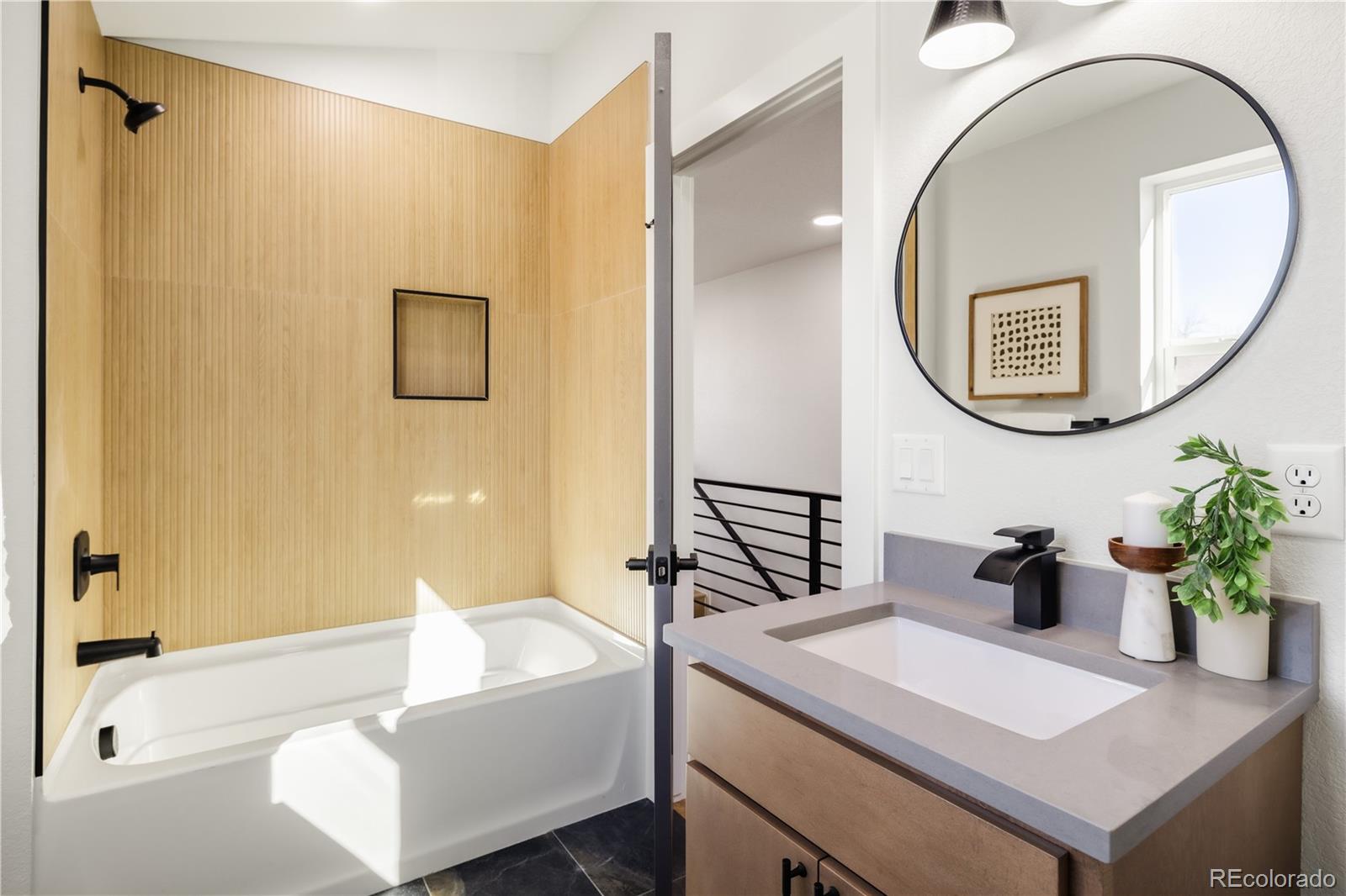 1343 Perry Street Denver, CO 80204 - Photo 7 of 37 a bathroom with a sink a bathtub and a mirror