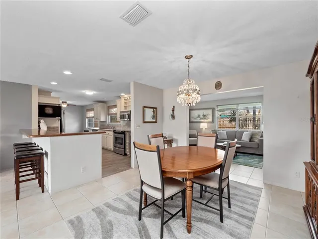 a large kitchen with stainless steel appliances granite countertop a stove and a sink