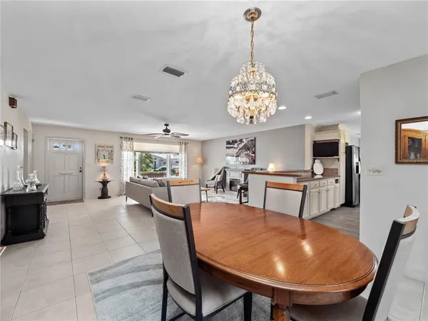 a view of a dining room with furniture and a chandelier