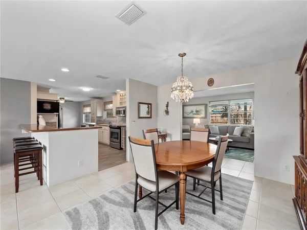 a large kitchen with stainless steel appliances granite countertop a stove and a sink