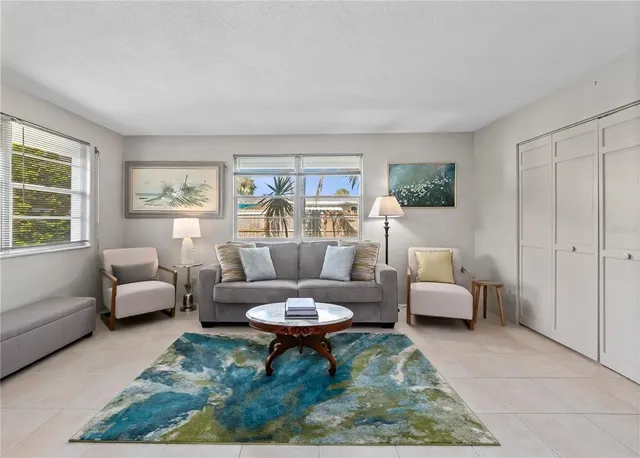 a spacious bedroom with a bed and a chandelier