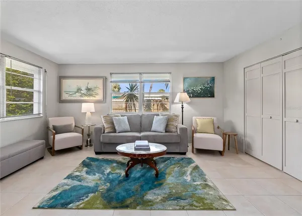 a spacious bedroom with a bed and a chandelier