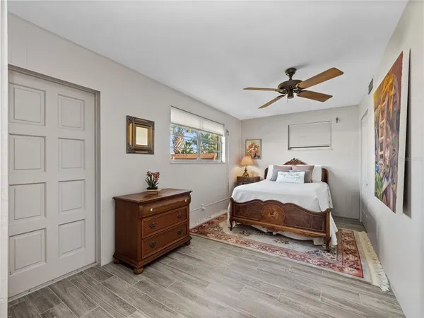 a bedroom with furniture and a window