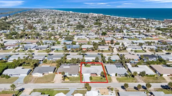an aerial view of residential houses with outdoor space