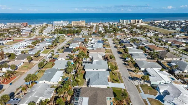an aerial view of a house with a garden and lake view