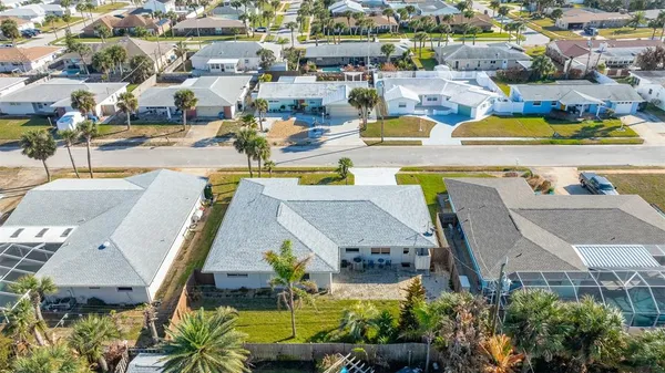 a front view of a house with a yard table and chairs