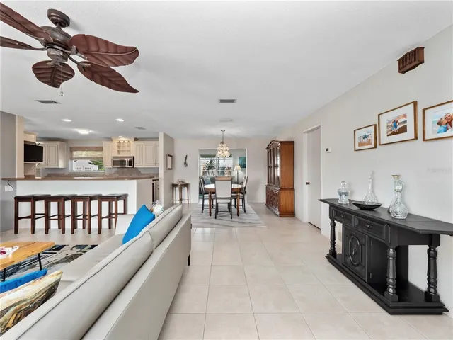 a living room with furniture and kitchen view