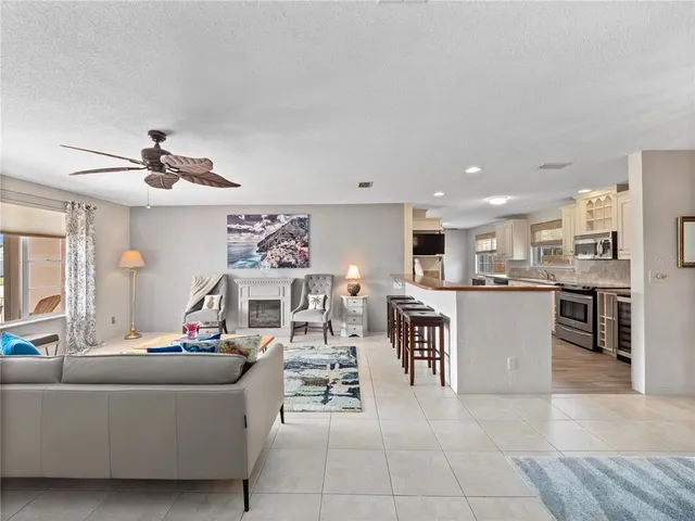 a living room with furniture a rug and a window