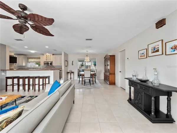 a living room with furniture and kitchen view