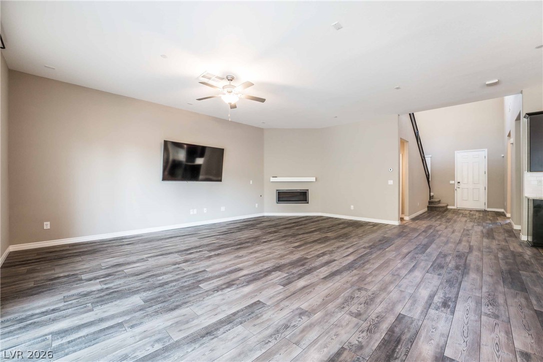 2787 Athens Ridge Drive Henderson, NV 89052 - Photo 4 of 31 A spacious great room with wide-plank flooring and a contemporary fireplace.