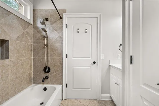 a bathroom with a bathtub a shower and a sink