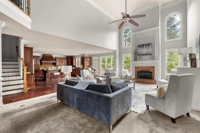 a living room with furniture a fireplace and a chandelier