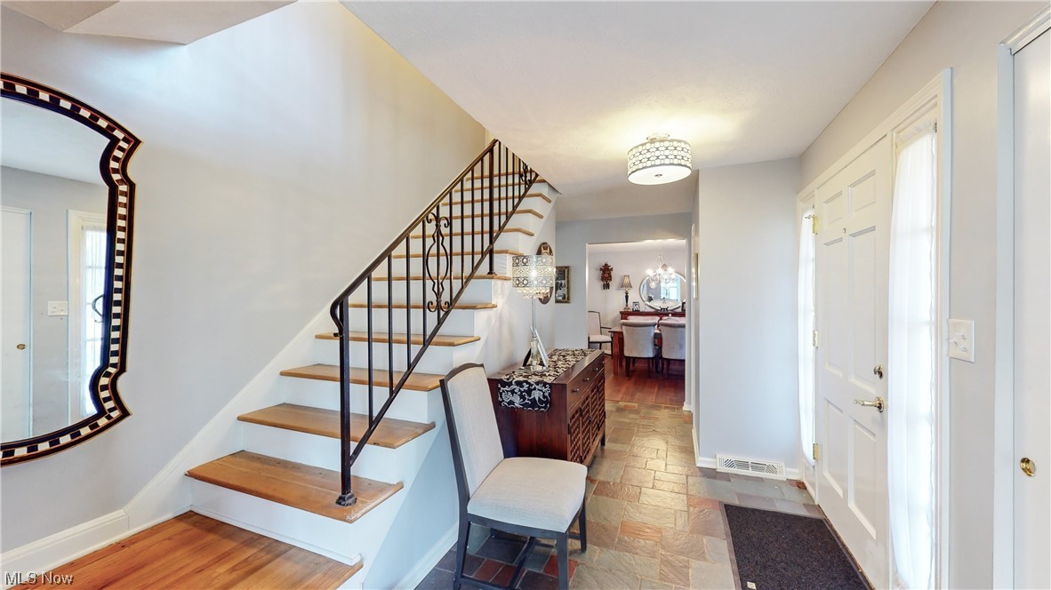 Entrance foyer with front hall closet and conveniently located half bath.
