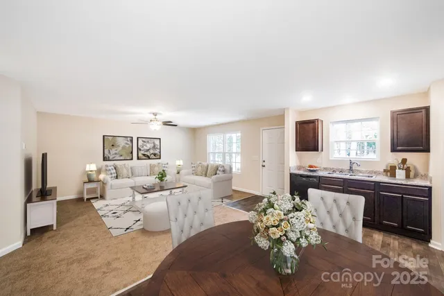 a living room with furniture large window and flat screen tv