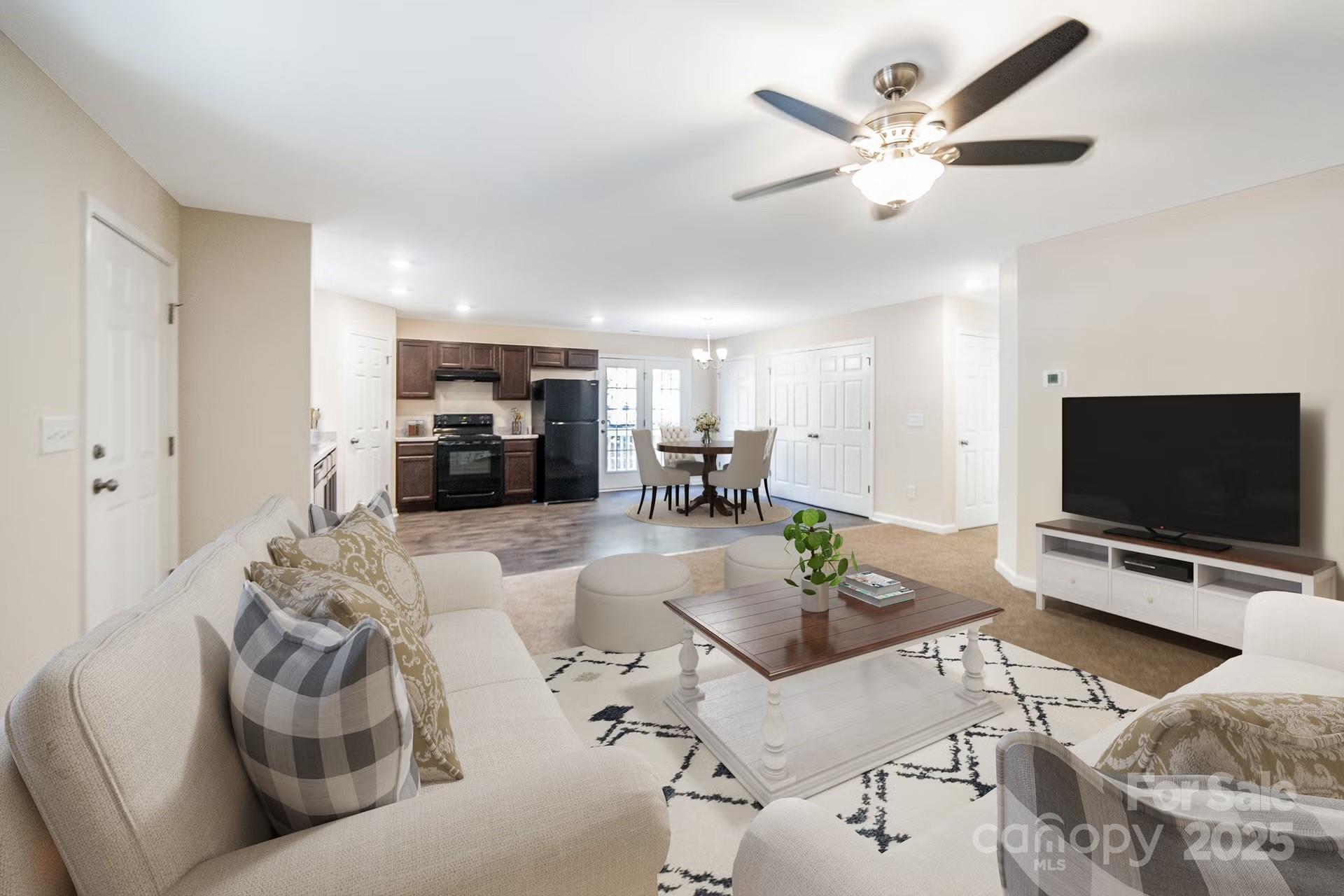 152 Moore's Lake Road, Unit 1 Wadesboro, NC 28170 - Photo 4 of 7 a living room with furniture and a flat screen tv with kitchen view
