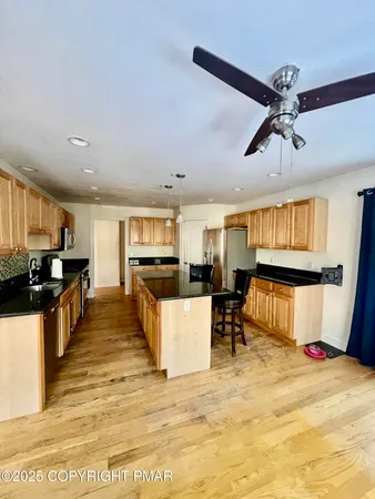 a living room with stainless steel appliances kitchen island granite countertop furniture and a kitchen view