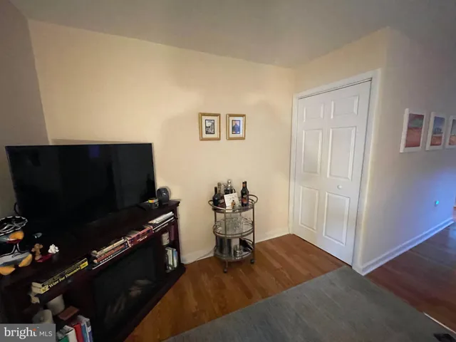 a view of a livingroom with furniture and a flat screen tv