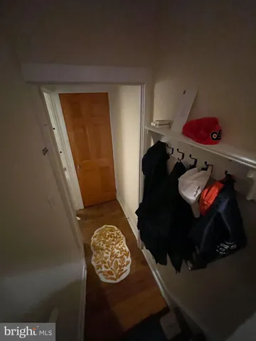 a bedroom with a bed and dresser with mirror