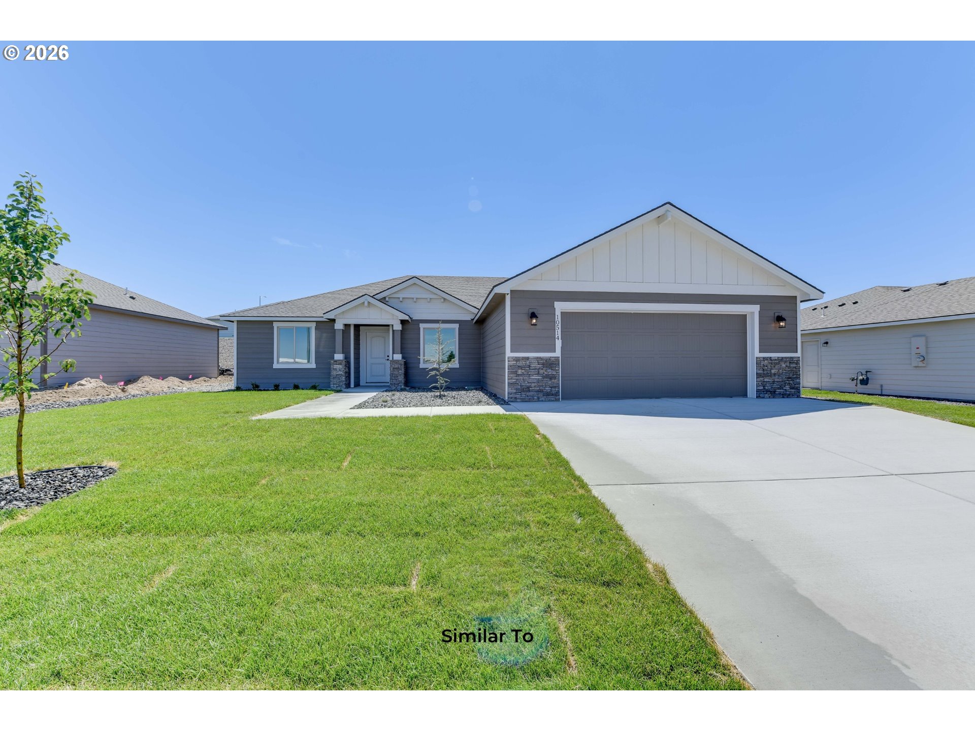 227 Southwest Goldfinch Lane Boardman, OR 97818 - Photo 1 of 28 a front view of a house with garden