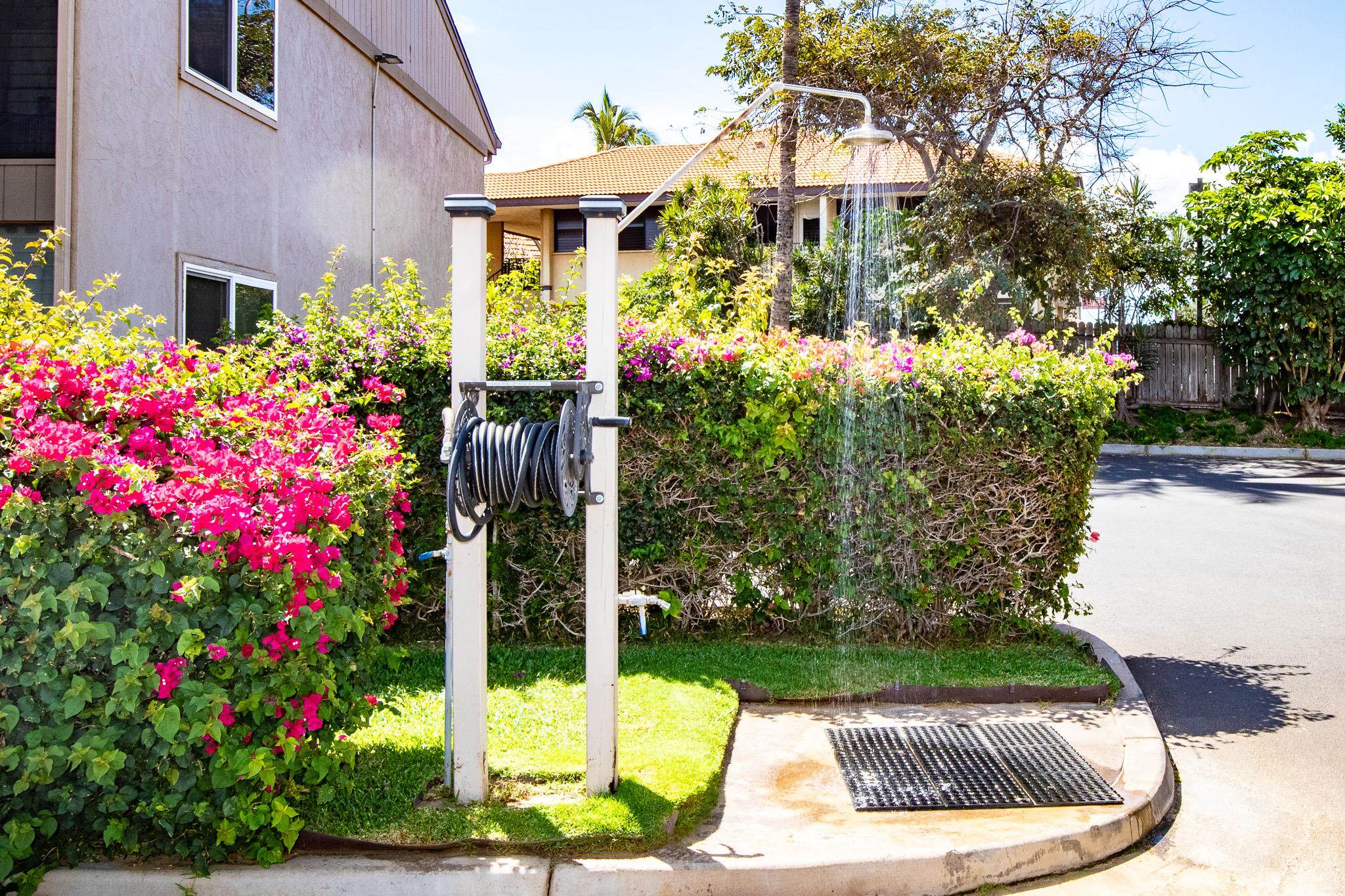 483 South Kihei Road, Unit 217 Kihei, HI 96753 - Photo 17 of 22 a front view of a house with a yard and fountain