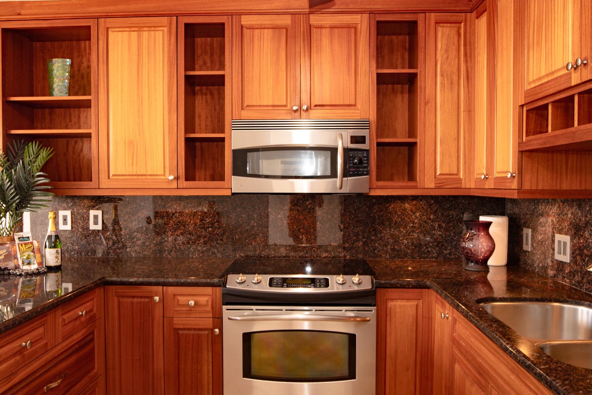 483 South Kihei Road, Unit 217 Kihei, HI 96753 - Photo 5 of 22 a kitchen with stainless steel appliances granite countertop a stove a sink and a microwave