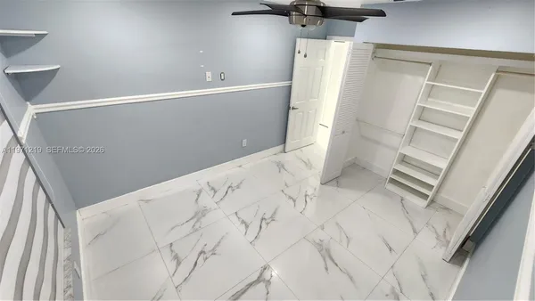 a white toilet sitting next to a bathroom sink