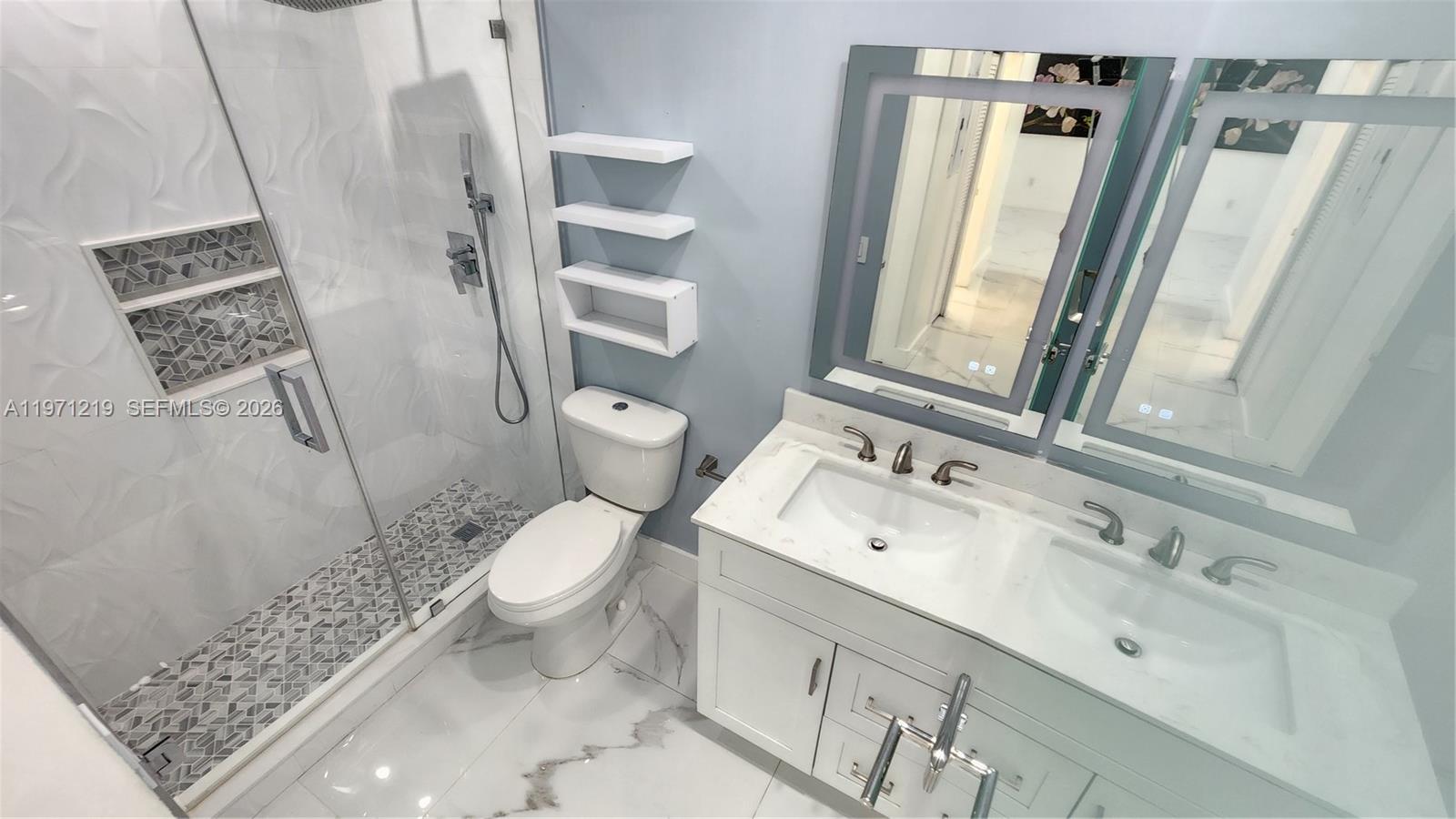 16515 Southwest 97th Street Miami, FL 33196 - Photo 17 of 38 a white toilet sitting next to a bathroom sink