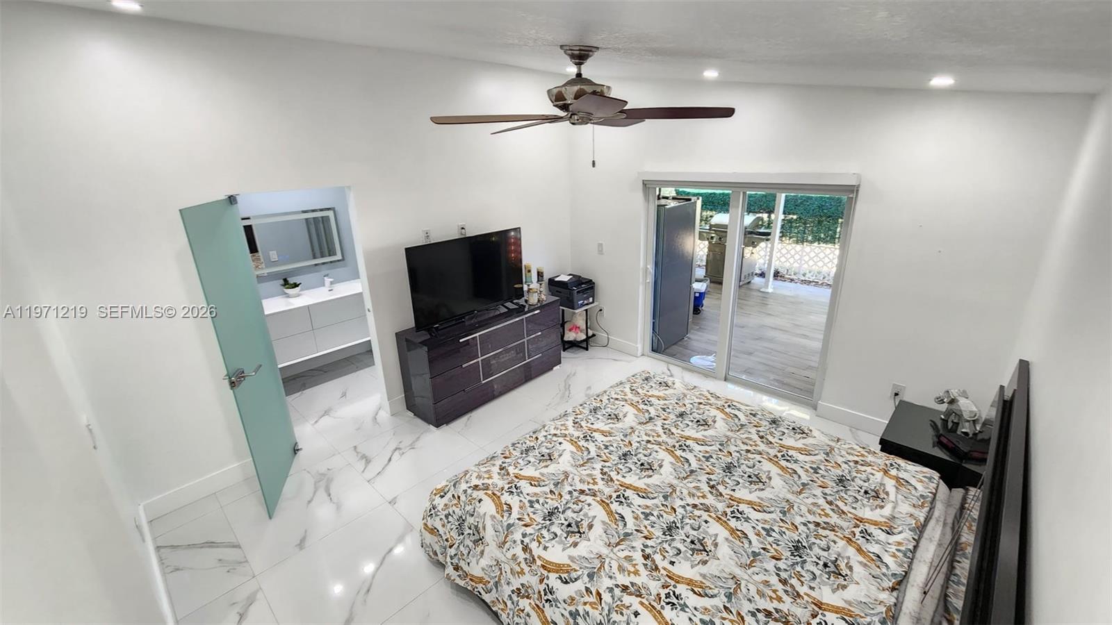 16515 Southwest 97th Street Miami, FL 33196 - Photo 20 of 38 a living room with a flat screen tv and a fireplace