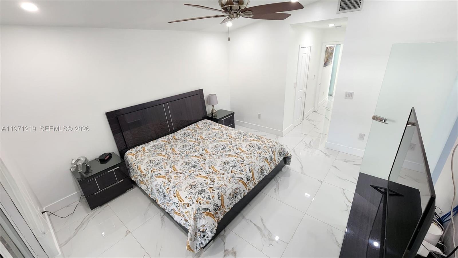 16515 Southwest 97th Street Miami, FL 33196 - Photo 21 of 38 a bed sitting in a bedroom next to a window