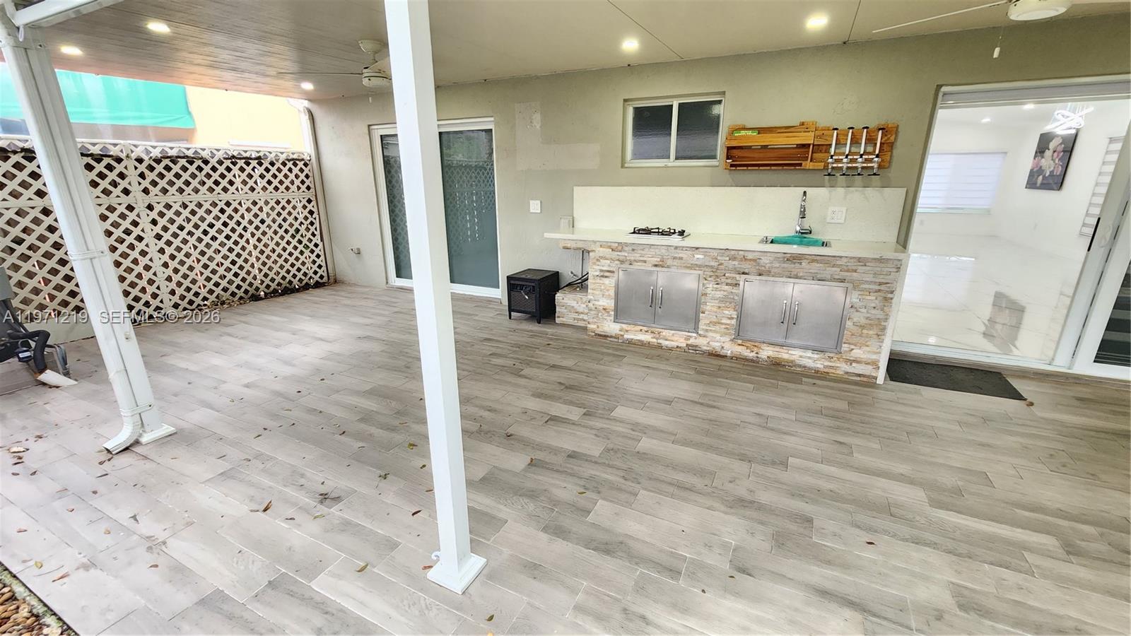 16515 Southwest 97th Street Miami, FL 33196 - Photo 29 of 38 a view of a kitchen with kitchen island and wooden floor