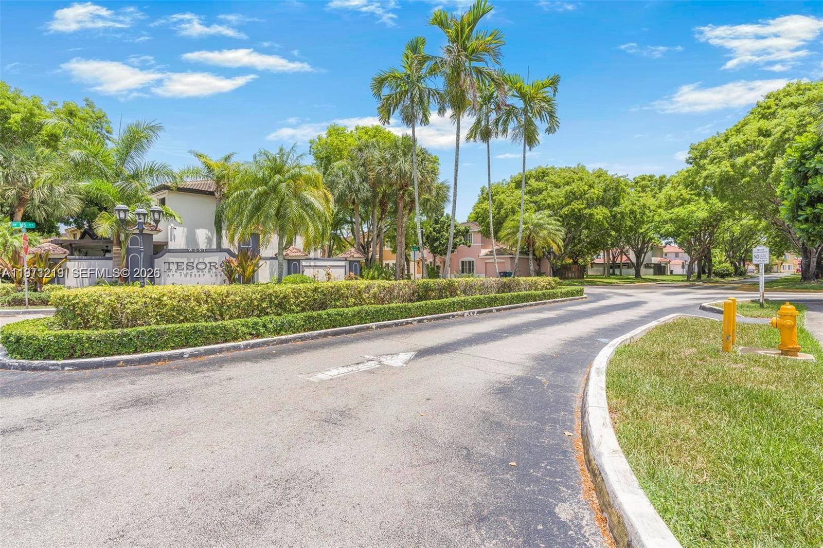 16515 Southwest 97th Street Miami, FL 33196 - Photo 35 of 38 a view of a swimming pool with a lawn chairs and palm trees