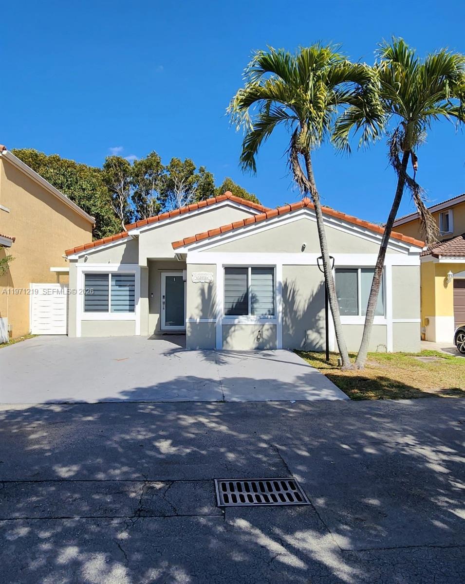 16515 Southwest 97th Street Miami, FL 33196 - Photo 38 of 38 a front view of a house with a yard and garage