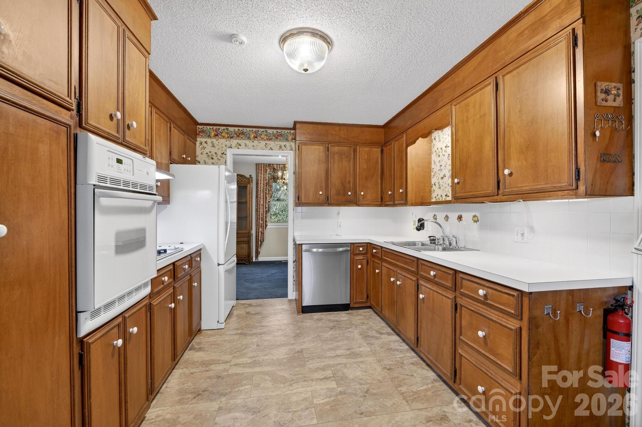 408 Spring Street Northwest Lenoir, NC 28645 - Photo 14 of 47 a kitchen with stainless steel appliances granite countertop a refrigerator and a stove