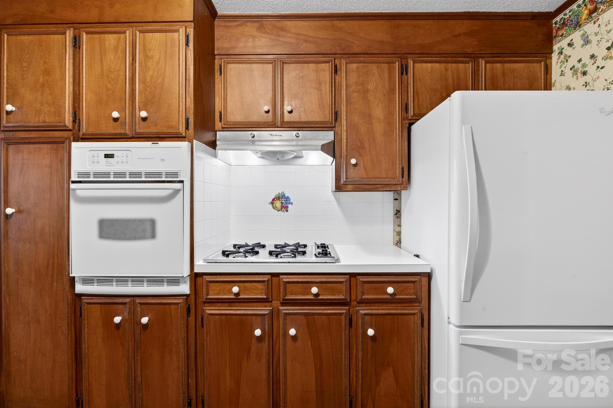 408 Spring Street Northwest Lenoir, NC 28645 - Photo 16 of 47 a kitchen with a refrigerator and a stove