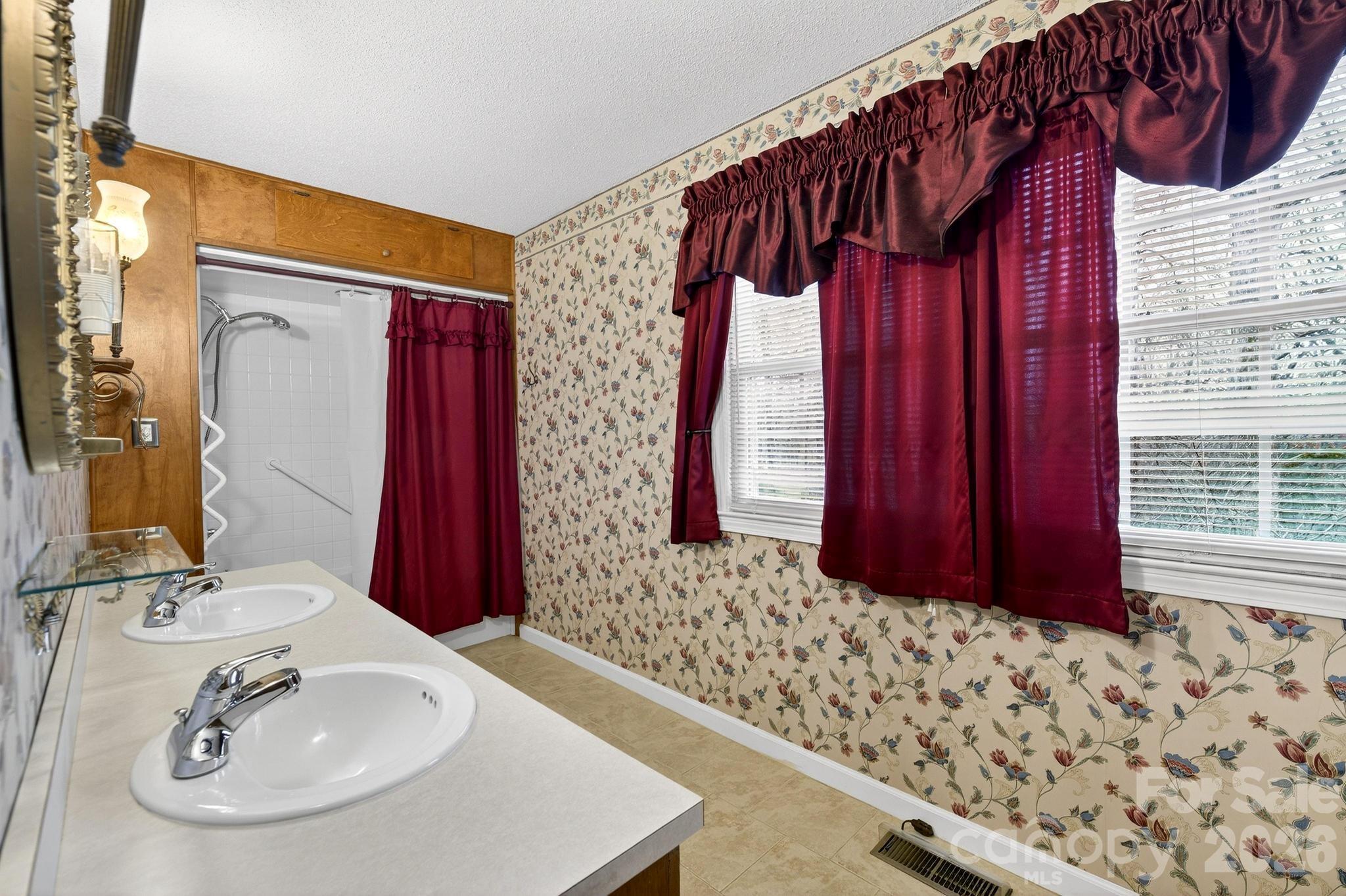 408 Spring Street Northwest Lenoir, NC 28645 - Photo 31 of 47 a bathroom with a sink and a mirror