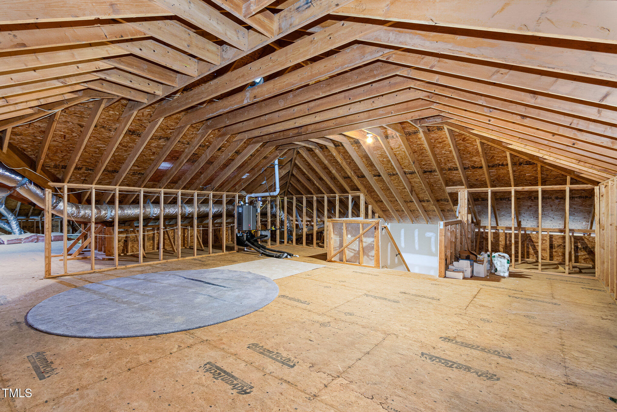 7814 Monument Lane Raleigh, NC 27615 - Photo 36 of 52 24x24 unfinished walk-up attic plus more storage in the HVAC area, new Rinnai tankless gas water heater