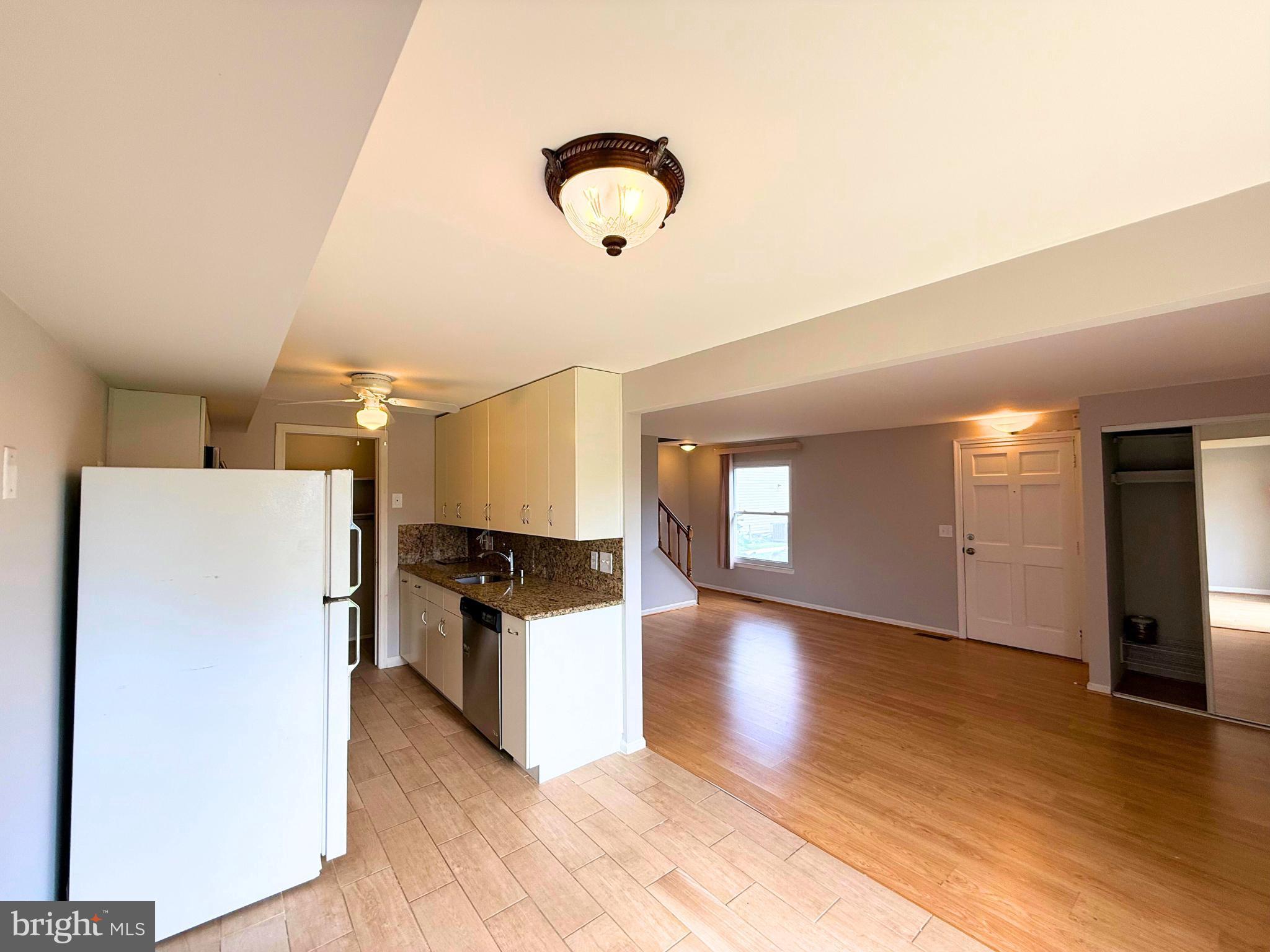 5 Coliston Road, Unit C Reisterstown, MD 21136 - Photo 2 of 39 a kitchen with stainless steel appliances granite countertop a refrigerator a stove and a wooden floors