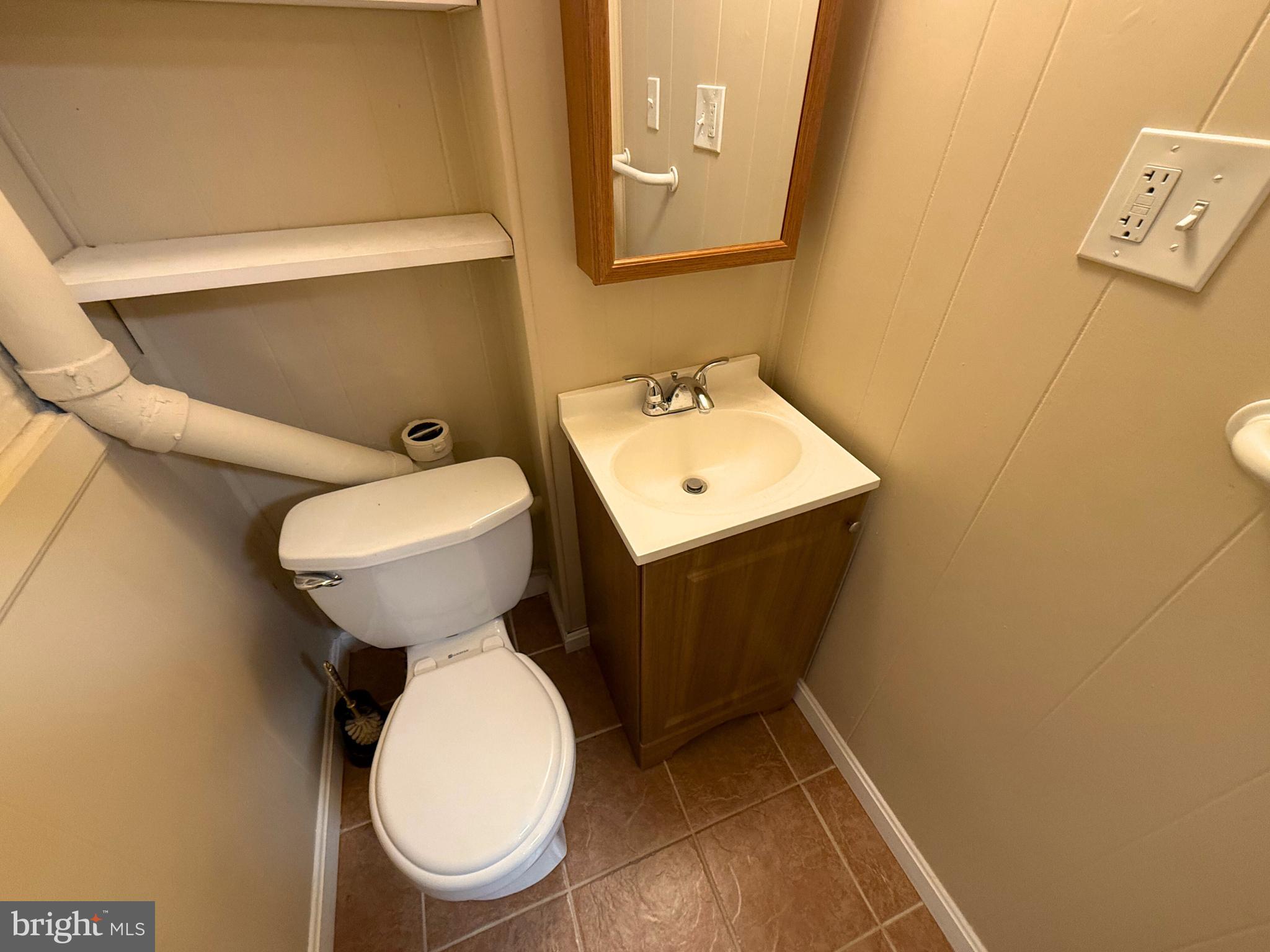 5 Coliston Road, Unit C Reisterstown, MD 21136 - Photo 21 of 39 a bathroom with a toilet sink and mirror