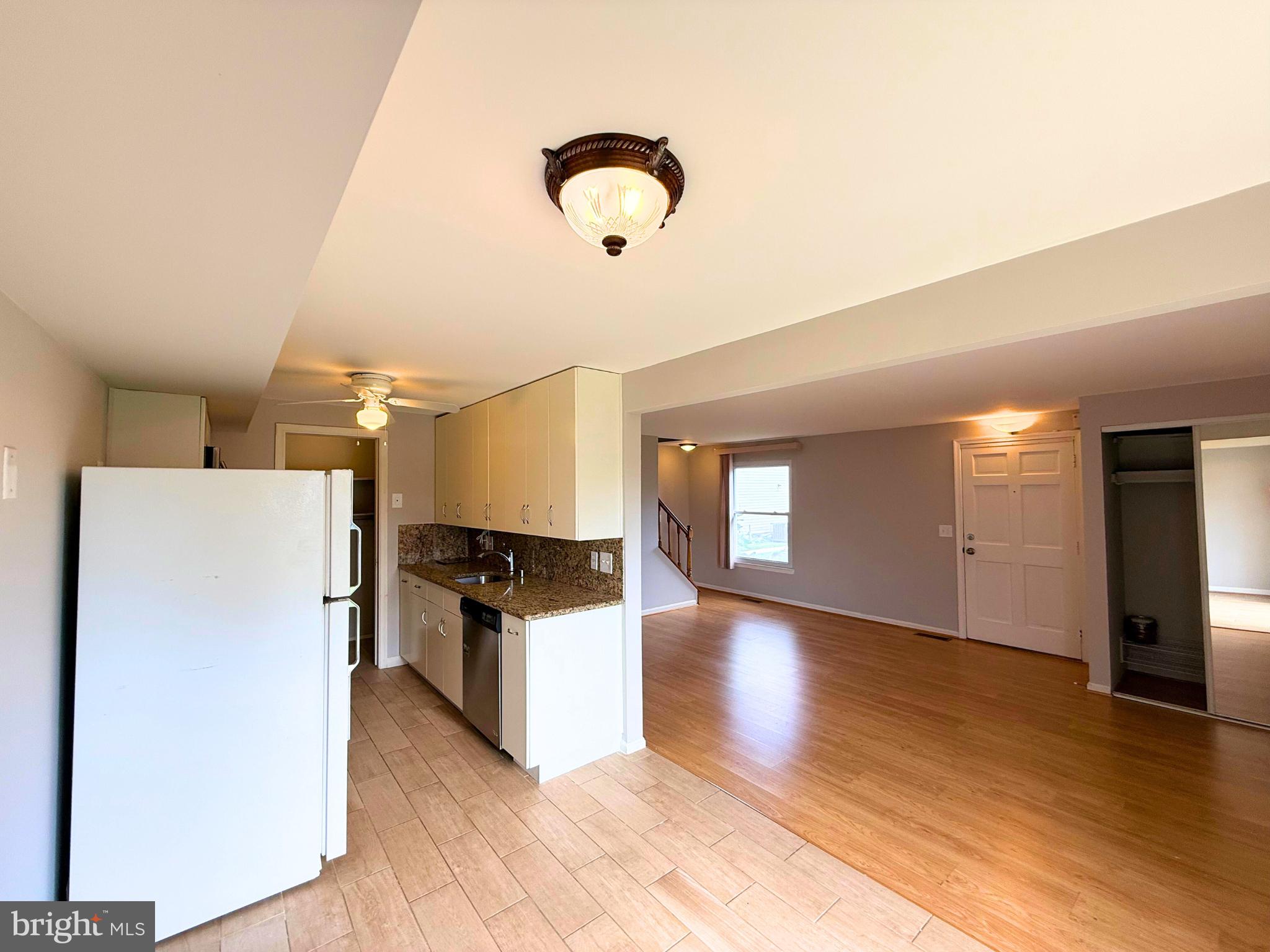 5 Coliston Road, Unit C Reisterstown, MD 21136 - Photo 7 of 39 a kitchen with stainless steel appliances granite countertop a refrigerator a stove and a wooden floors