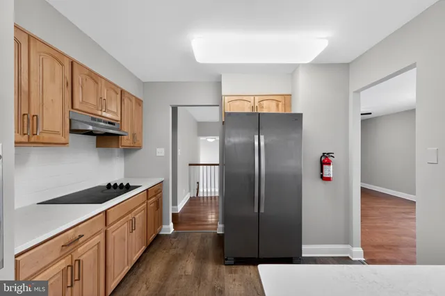 a kitchen with stainless steel appliances granite countertop a refrigerator and a sink