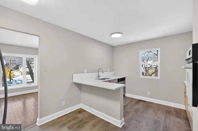 a view with cabinets and wooden floor