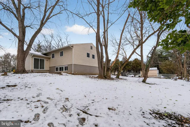 a view of a house with a snow in the yard